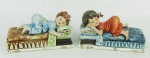 Duas estatuetas em biscuit italiano policromado com marca da manufatura Capodimonte, numeradas e assinadas Maria Angela nas bases, representando "crianças em repouso". Meds. 7,5x15x6,5cm.