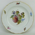 Meissen - Prato de coleção em porcelana alemã, com marca da manufatura no verso, decorado com pintura de flores, folhas, frutos e borboletas em policromia. Diam. 21cm.