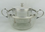 Porta caviar em cristal, possivelmente da Cristallerie Baccarat, decorada na base com lapidação de estrela com 24 pontas. Guarnições em metal espessurado a prata. Minúsculas marcas de uso. Med. 20x35,5x25cm.