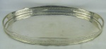 Grande bandeja oval em metal espessurado a prata. Gradil com trabalhos de flores, folhagens e detalhes vazados. Med. 5x60,5x40cm.