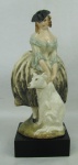 Guido - Escultura em faiança italiana, policromada, representando "Dama com cão". Assinada e localizada. Base em madeira. Alt. total 19cm.