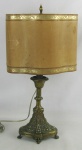Abajour em bronze, decorado com trabalhos de perolados e folhagens em relevo. Cúpula em papel pergaminho, com detalhes em dourado. Alt. 50cm.