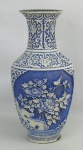Vaso em laca oriental no tom azul e branco, decorado com trabalhos em relevo de flores, folhagens, pássaro, gregas e arabescos. Parte interna em metal dourado. laca com pequenas perdas. Alt. 31,5cm