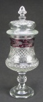 Compoteira de pé alto em cristal translúcido com lapidações bico de jaca e em sulcos. Decorada com faixa no tom lilás, com lapidações em satiné de flores e folhas. Alt. 35cm.