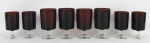 Vinte e sete taças em vidro francês, na cor rubi, com hastes e bases translúcidas, sendo 15 de um tamanho e 12 de outro. Alts. 11,5 e 9,5cm.