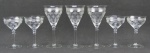 Doze taças em cristal translúcido, com lapidações de flores e folhagens ao estilo St. Louis, sendo 6 para vinho e 6 para champagne. Uma para vinho e uma para champagne com um bicadinho na borda. Alts. 19,5 e 14,5cm.