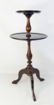Mesa de apoio com 2 platôs circulares, em madeira entalhada. Coluna torneada com 3 pés recurvos. Alt. 66,5 cm.