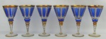 Seis belas e raras taças em cristal na tonalidade azul e translucida. Lapidações de sulcos e facetados. Ricos detalhes em dourado. Alt. 16m.