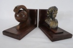 Par de Serre - Livres base em madeira com escultura representando "Busto de Carlos Gomes" em petit bronze com resquicio de douração e " Globo Terrestre". Med. 16 cm alt x 11 cm larg x 9 cm diâmetro.