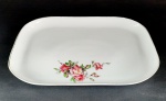 Travessa retangular rasa em porcelana manufatura Real, na cor branca com desenhos florais e borda dourada. Medidas aproximadas comprimento 35 cm, largura 23 cm e altura 3 cm