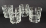CHRISTOFLE  CONJUNTO COM QUATRO LINDOS COPOS EM CRISTAL LAPIDADO PARA WISKY. MARCA DA MANUFATURA ACIDADA SOB A BASE. ELEGANTEMENTE LAPIDADA EM SULCOS HORIZONTAIS E VERTICAIS. ALEMANHA, SEC. XX. 9,5 X 9 CM