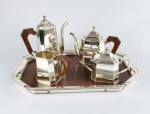 SAINT JAMES  BELO JOGO DE CHÁ E CAFÉ COM SEU TABULEIRO CONSTRUIDOS EM METAL ESPESSURADO A PRATA E MADEIRA. COMPOSTO DE GRANDE  CAFETEIRA, BULE DE CHÁ, CREMEIRA E AÇUCAREIRO. O TABULEIRO TEM FEITIO OCTAVADO ASSSIM COMO AS PEÇAS. BRASIL , SEC. XX. 54 CM DE COMPRIMENTO (O TABULEIRO)