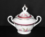 Espetacular açucareiro manufatura STEATITA com decoração com flores e adornado com figuras geométrica à ouro com fundo vinho, pega no formato de balão vazado  com pegas em ambas as laterais. altura de 14cm