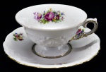 PORCELANA KPM - Parte de aparelho de jantar de porcelana polonesa KPM, branca, decorada com motivo floral em policromia e filetado a ouro. Composta de: 1 xícara de chá com pires. Med. 6 cm e 15 cm.