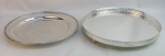 Duas peças em metal espessurado a prata, sendo salva com borda e pés vazados e bandeja circular com marca da manufatura Woff. Diams. 40,5 e 39 cm.