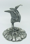 Paliteiro de coleção em prata portuguesa, contraste Javali na forma de cegonha com galho no bico. Apresenta discretíssima fissura no pescoço. Alt. 14,5 cm.