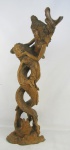 Grande escultura tailandesa em raiz de nogueira entalhada representando "Cena com figuras mitológicas", sendo estas metade humanos e metade peixe. Pequenas marcas do tempo na madeira. Alt. 85,5cm.