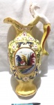 Belíssimo vaso produzido em porcelana com bela decoração floral e alça com representação de figura mitológica, altura 46cm, com restauros.