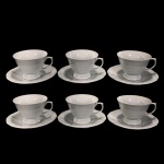 SCHMIDT - SEIS XÍCARAS DE CHÁ EM PORCELANA SCHMIDT NA COR BRANCA, COM BORDAS EM DETALHES EM ARABESCO EM ALTO RELEVO NA MESMA COR.