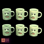 SEIS CANECAS EM CERÂMICA ESMALTADA NA COR VERDE COM DECORAÇÃO DE CARINHAS - SEM USO - MED 7 X 6 X 9 CM. - NA CAIXA. 