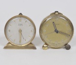 CYMA - Lote composto por 02 relógios de mesa de coleção com caixa em metal dourado, máquina a corda e mostradores numéricos com despertador. Med: 7cm (Sem garantia de funcionamento)