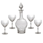 Conjunto de licoreiro de cristal translucido com corpo bojudo. Tampa na forma de pinha. (31.5 cm). Acompanha quatro taças com a mesma decoração (15 cm).
