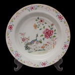 SERVIÇO DOS PAVÕES  Prato fundo de formato circular em porcelana Companhia das Índias, pertencente ao Serviço dos Pavões. Apresenta decoração nos esmaltes da Família Rosa, tendo no centro casal de pavões entre peônias e ramos, circundados por guirlandas floridas. China. Dinastia Qing (1644-1917). Reinado Qianlong (1736-1785). 23 cm. Peça do mesmo serviço reproduzida na pág. 97 do Livro "Louça da Aristocracia no Brasil", por Jenny Dreyfeus.