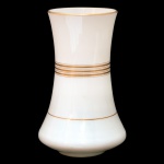 Vaso no formato de corneta em opalina de cor branca, ornamentado por frisos a ouro. Bojo abaulado com borda revirada, apoiado em base circular retraída. 20 cm.