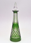 Licoreiro em cristal francês da manufatura de Saint Louis. Corpo soprado em formato cônico com camadas "double" de verde sob incolor. Bojo profusamente lapidado com elementos geométricos sob gargalo multifacetado. Tampa sextavada de formato triangular. França. Início do século XX. 28 cm.