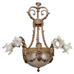 Lustre francês para seis luzes em bronze lavrado com adornos florais e cristal acetinado lapidado com estilizações. Cúpula inferior encimada por friso em coroa ornamentada com máscaras e guirlandas. Braços recurvos e tulipas com bordas onduladas. Hastes laterais arqueadas reunidas ao topo por argola com volutas. Seis lâmpadas externas e três internas.  97 x 72 cm. Apresenta uma cúpula diferente (adaptada) e uma colada.