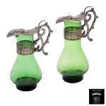 Conjunto de galhetas de vidro na cor verde vidro na cor verde. Tampa e pegas de metal prateado. Marcas do material Peltro e do fabricante MFS.  13 x 9 x 6 cm. Lote pertencente ao acervo de tradicional família paulistana de Américo Moreira dos Santos e Anella Mafalda Malzoni.