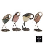 Conjunto de quatro estatuetas em prata representando garças com corpos em pedra polida. Marcas do teor de 925 mls e do fabricante Silver Brazil. 14 x 8 x 5 cm. Lote pertencente ao acervo de tradicional família paulistana de Américo Moreira dos Santos e Anella Mafalda Malzoni.