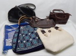 DIVERSOS, seis (6) itens: 1 bolsa feminina em trama industrial de barbante, detalhes em casca de coco polida, alça média, medindo 35 x 28 cm; 1 bolsa feminina em trama de algodão e espuma, souvenir da Grécia, tonalidade azul e branca, alças média, medindo 37 x 31 cm; 1 bolsa feminina em tricô ou crochê, geométrica, tonalidade azul e branca, alças em flechas curvadas, medindo 37 x 32 cm; 1 bolsa feminina confeccionada em couro, tonalidade marrom, marca UNCLE K, interior em tecido laranja, alças curtas, medindo 22 x 16 x 9 cm; 1 bolsa feminina, marca UNCLE K, confeccionada em couro ecológico marrom, interior em tecido lilás, alça curta, medindo 30 x 12 cm; 1 bolsa feminina na tonalidade preta, marca GILSON MARTINS, couro ecológico, alças curtas, medindo 35 x 20 cm.