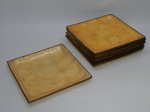 DIVERSOS, doze (12) pratos quadrangulares, ligeiramente abaulados, confeccionados em polímero com texturização nacarada, medindo 25 x 25 cm, borda em metal dourado, um deles com falhas na borda.