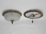 LUMINÁRIA, dois (2) lustres de teto com estrutura em bronze vazado e relevado em elementos vegetalistas, plafom incolor e translúcido, fosqueado na técnica satinê, lapidado em palmas, sulcos e gotas, medindo 27 cm diâmetro, falta o plafom de um deles, não possuem a parte elétrica.