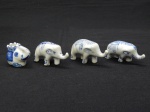 PORCELANA, quatro (4) esculturas representando elefantes, pintadas a mão na técnica blue and white, medindo a maior 6,5 cm.