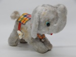 BRINQUEDO, um (1) elefante de pelúcia e outros materiais, mecanismo a corda funcionando, quando acionado a cauda roda e as pernas abaixam e levantam, medindo 20 cm altura, funcionamento sem garantia.