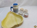 Lote composto de bule em porcelana, 4 xícaras de chá/café com leite em porcelana e fruteira na forma de pera em resina. Medindo a fruteira 33cm x 28cm x 5cm de altura.