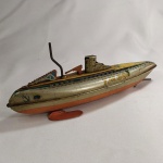 BRINQUEDO ANTIGO - SUBMARINO MILITAR em LATA, fabricado no Japão pela MODERN TOYS (SUBMARINE TM-300). Mede aprox. 24 centímetros de comprimento. A corda não está funcionando, necessitando revisão caso o comprador assim o queira. Ausência da hélice e do suporte traseiro.