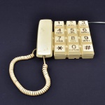 Telefone da WEBCOR, Anos 90, na cor marfim com grandes teclas quadricular, números em relevo pintados de preto. Pequena perda na quina superior do fone.  Não testado. 22x21x6 cm