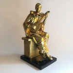 Antiga e robusta escultura "PIERROT" em metal revestido de dourado sobre base retangular. Dimensões: 37 cm x 19 cm x 14,5 cm / 5 kg.