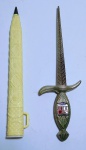 Colecionismo - Lindo e curioso abridor de cartas e caneta no formato de punhal, em metal prateado ostentando brasão da cidade Francesa-Lourdes. Bainha em plástico rígido, contendo caneta BIC - Porém sem carga - Moucheront - Made In France - Medida total com a bainha: 19 x 4,5 x 1 cm.