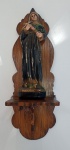 Belíssima peanha em madeira nobre com imaginária de Santa Rita em estuque, medindo 46 cm x 15 cm.