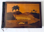 ANOS 50 - Álbum com capa em madeira decorada com paisagem do Rio de Janeiro. Med. 29x45 cm.