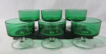 VIDRO - Seis taças para sobremesa confeccionadas em vidro na cor verde, seguido de haste lisa e base circular em vidro translúcido. Medidas alt 8 cm x diam 8,3 cm x diam da base 7 cm.