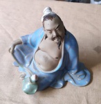 Esplendorosa Estatueta de figura oriental obesa em cerâmica vitrificada com quimono azul claro. Alt. 12cm