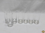Jogo de 7 copos de vodka em vidro incolor, sendo 4 maiores com 10 cm de altura e 3 menores com 9cm de altura.