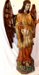 Escultura Brasileira em madeira representando, "figura de anjo" com fina policromia.        Pedestal em forma de nuvens. Séc. XX.                                                                                                                     Medidas:  Alt. 185 cm.  x  Larg. 115 cm.