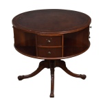 Mesa livreiro, estilo regency, caixa circular revestida de couro pirogravado,  coluna central finalizada sobre quatro pés. Possui 6 gavetas com puxadores em metal. Retirada na Barra com hora marcada. Medida:  72 alt x 82 diâmetro.
