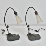 Par de luminárias em metal com trabalhos em alto relevo representando figuras de folhas em sua base - Manga em vidro transparente - Medidas : 38 cm alt x 16 cm comp x 12 cm prof.